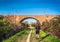 Man jogging urban park bridge railway path trail in the city background