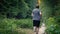 Man Jogs On Dusty Gravel Path Through Sunset Forest