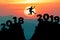 Man jump between 2018 and 2019 years. Happy new year 2019 concept for the achievement.