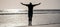 Man jumping, banner with copy space. healthy man silhouette raised hands on beach. energetic summer. feel freedom.