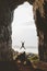 Man jumping in cave Travel adventure vacations happy emotions