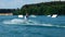 A Man Jumping His Wakeboard Off A Ramp At Cable Park, Slow Motion. Water Skiing