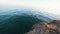 Man jumping off of the cliff and dives into the Mediterranean sea