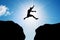 Man jumping over precipice. Risk, challenge, success.