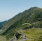 A man jumping with parachute and flying over Transfagarasan road.