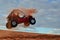 Man Jumping Quad Through the Air on Sand Dune