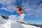 Man jumping with snowboard from mountain hill