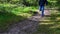 A man jumps down a slope in a forest and loose ground