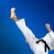 Man in karategi beats a straight kick