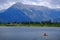 Man on Kayak on Lake Mountains Wilderness Paddling