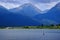 Man on Kayak on Lake Mountains Wilderness Paddling