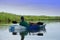 Man on Kayak on lake overlooking landscape