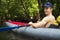 Man in kayak with oar. Kayaking. Young man in boat on canoe
