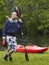 Man With Kayak Paddle Standing On Grass