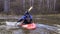 Man kayaker rowing in a boat against the current.