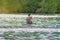 Man kayaking at flooding river