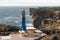 Man keep balance standing on his hands on Sea scape with dangerous vertical cliff background, cloudscape during sunset