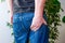 Man keeps hand on lower part of buttocks. Concept photo manifestations of pain at exit of sciatic nerve, inflammation, sciatica or