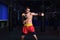 Man kickboxer is practicing kick in a boxing gym
