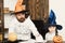 Man and kid with serious faces play with pumpkins