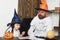 Man and kid with serious faces in witch hats