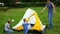 A man with kids gathering tent