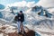 A man kisses a woman in the lips against the backdrop of snowy mountains. Holidays in the mountains