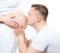 Man kissing belly of his pregnant woman wife