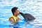 Man kissing dolphin in pool