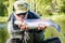 Man kissing trout fish