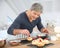 Man in kitchen preparing pastries