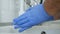 Man in the Kitchen Washing His Hands Wearing Blue Rubber Gloves