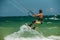 Man Kitesurfing in blue sea