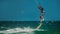 Man Kitesurfing in blue sea