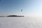 Man is kiting on skis on the frozen river