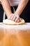 Man kneading dough on flour covered table