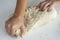 Man kneading a large dough for homemade bread in quarantine