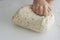 Man kneading a large dough for homemade bread in quarantine