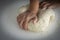 Man kneading a large dough for homemade bread in quarantine