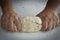 Man kneading a large dough for homemade bread in quarantine