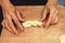 Man kneading raw donut dough