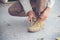 Man kneel down and tie shoes industry boots for worker. Close up shot of man hands tied shoestring for his construction brown