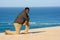 Man kneeling on beach