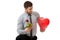 Man kneeling with red rose and heart balloon.