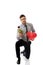 Man kneeling with red rose and heart balloon.