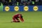 a man that is kneeling on some grass with his feet on the ground