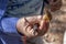 Man with a knife holding a yellow `Weeping bolete` mushroom