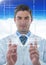 Man in lab coat holding up glass device with white interface against blue sky with cloud