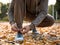 Man lacing his sportive shoes getting ready for jogging in atumn park.