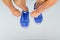 Man lacing sport shoes on aluminium floor in fitness